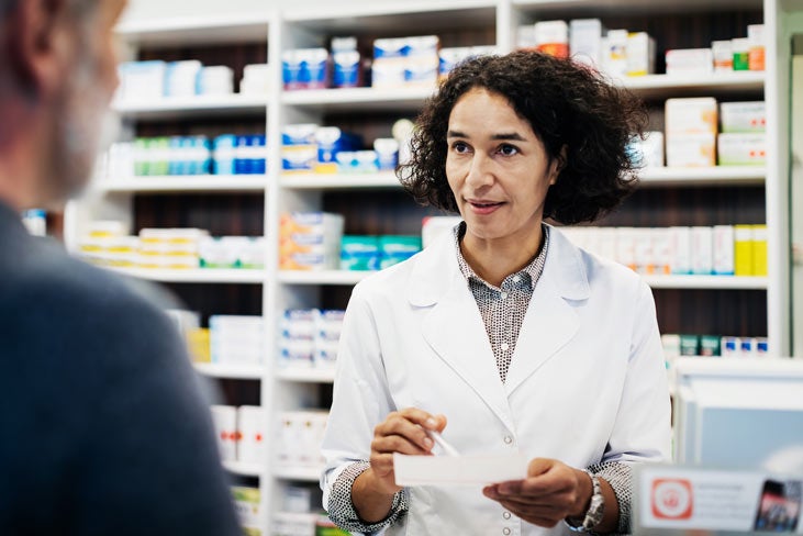 A pharmacist talks to a patient about their medication