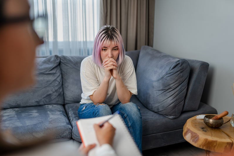 Young woman talking with her therapist
